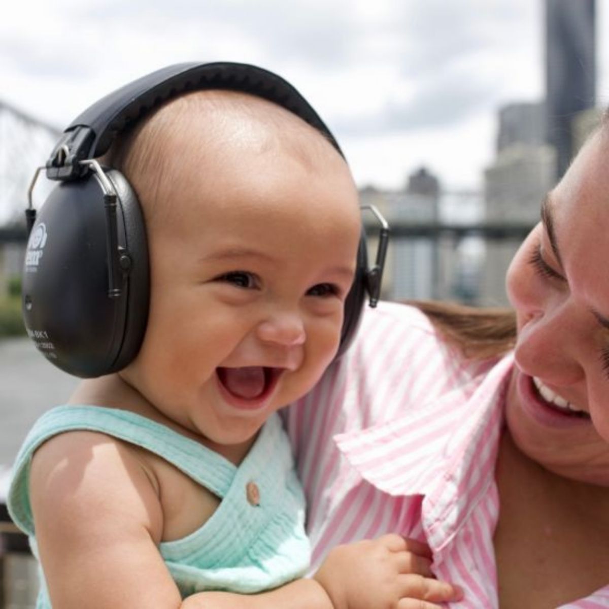Baby wearing earmuffs whilst out and about.