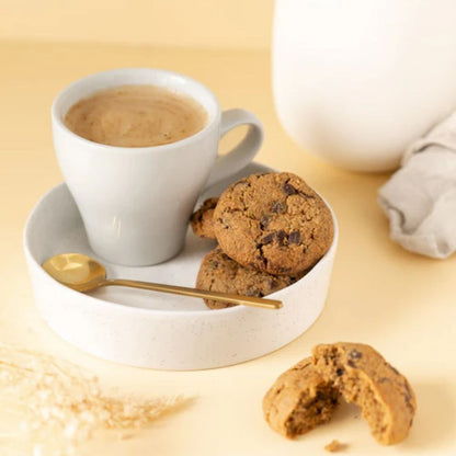 A breastfeeding mother enjoy her Milk Collective Lactation Cookies with her coffee.