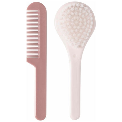 A pink coloured brush and comb set for babies, designed to help prevent cradle cap and stimulate hair follicles.