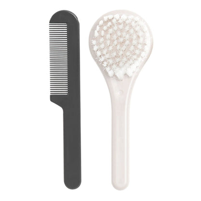 A black and cream coloured brush and comb set for babies, designed to help prevent cradle cap and stimulate hair follicles.