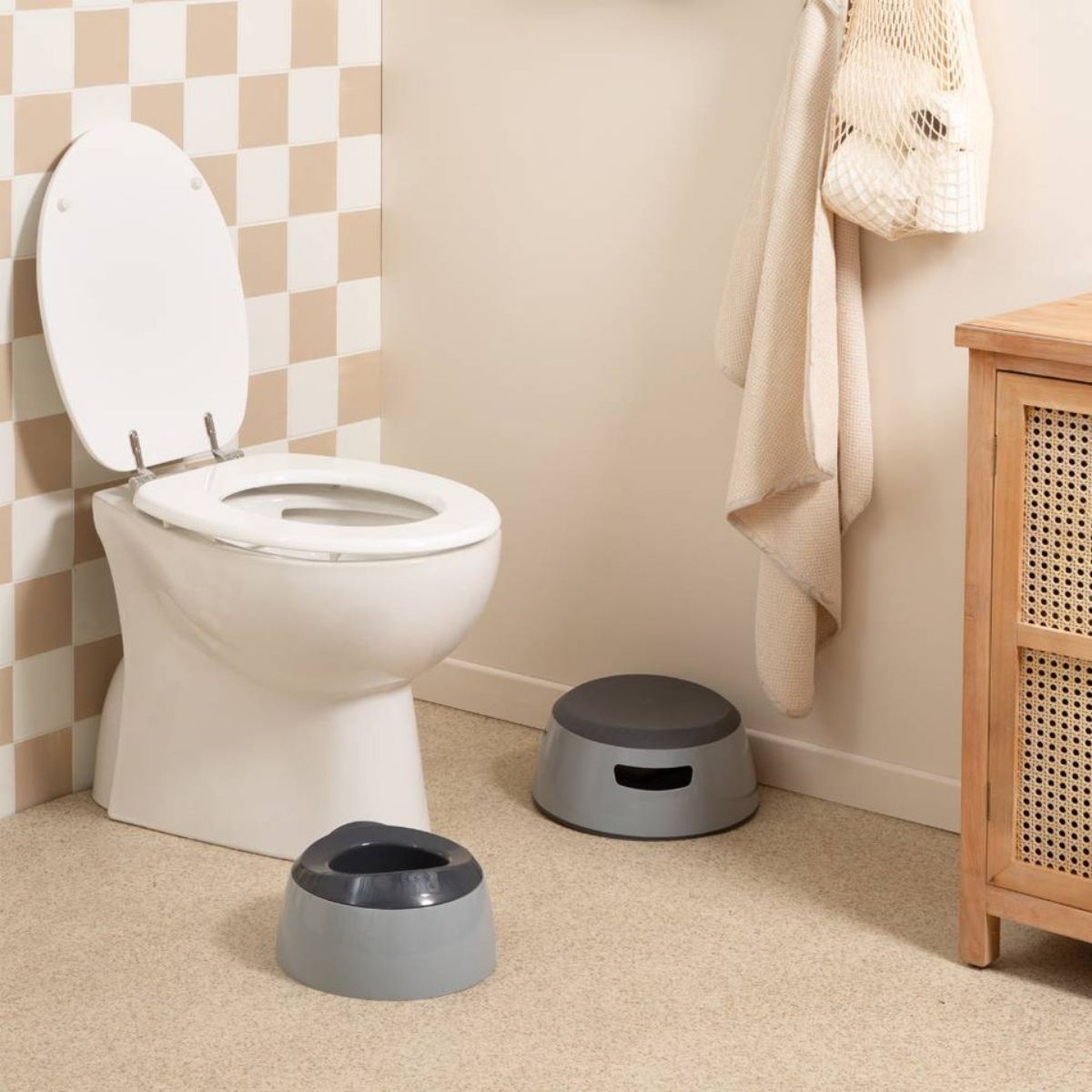 Two blue potty stools in front of a white toilet in a bathroom.
