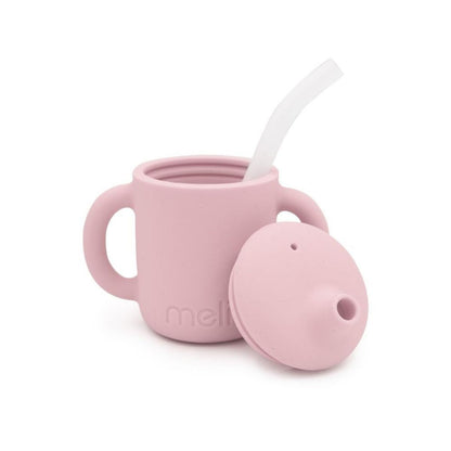 A pink 3-in-1 training cup for kids to drink hot or cold drinks with the straw or as an open cup,