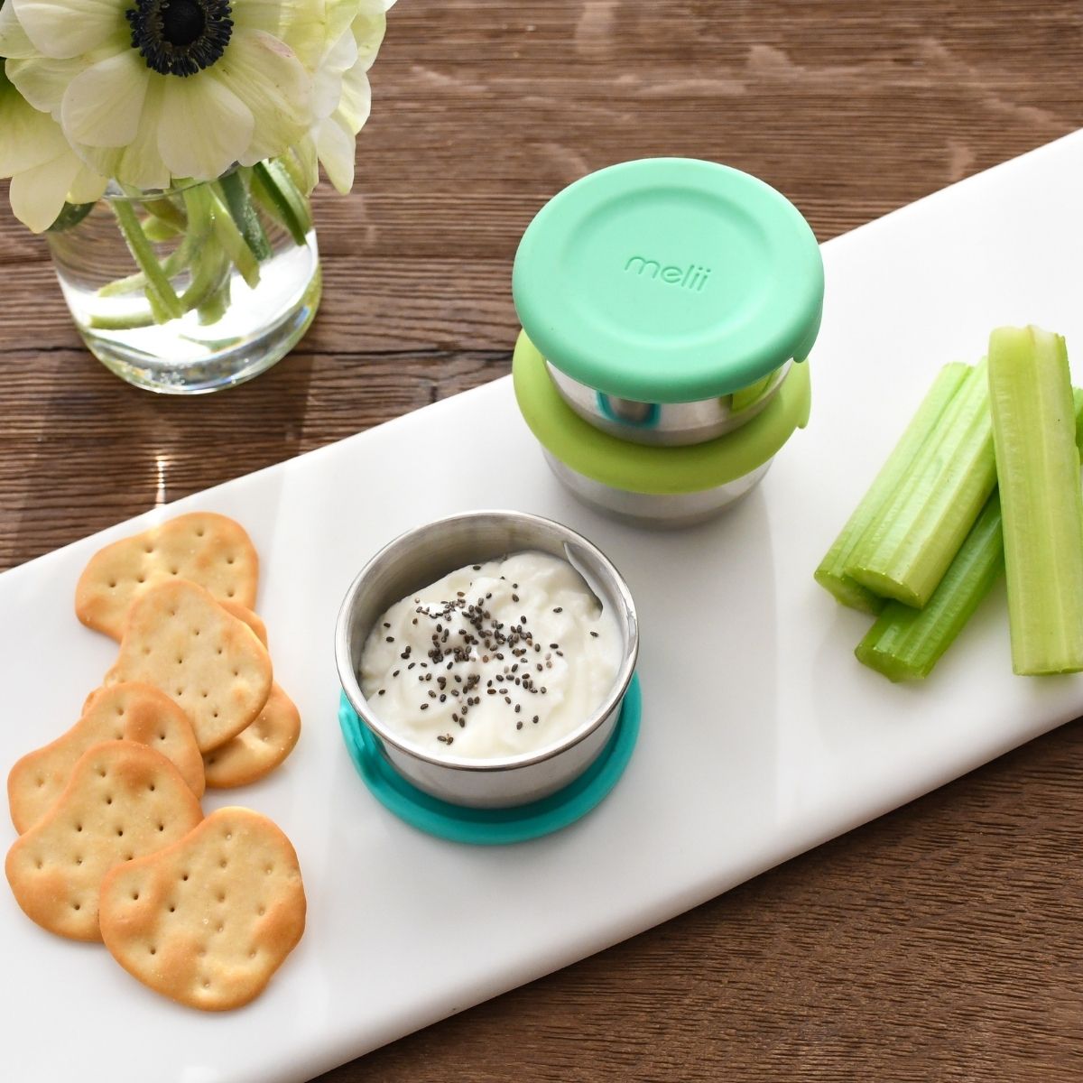 The containers on a platter filled with yogurt.