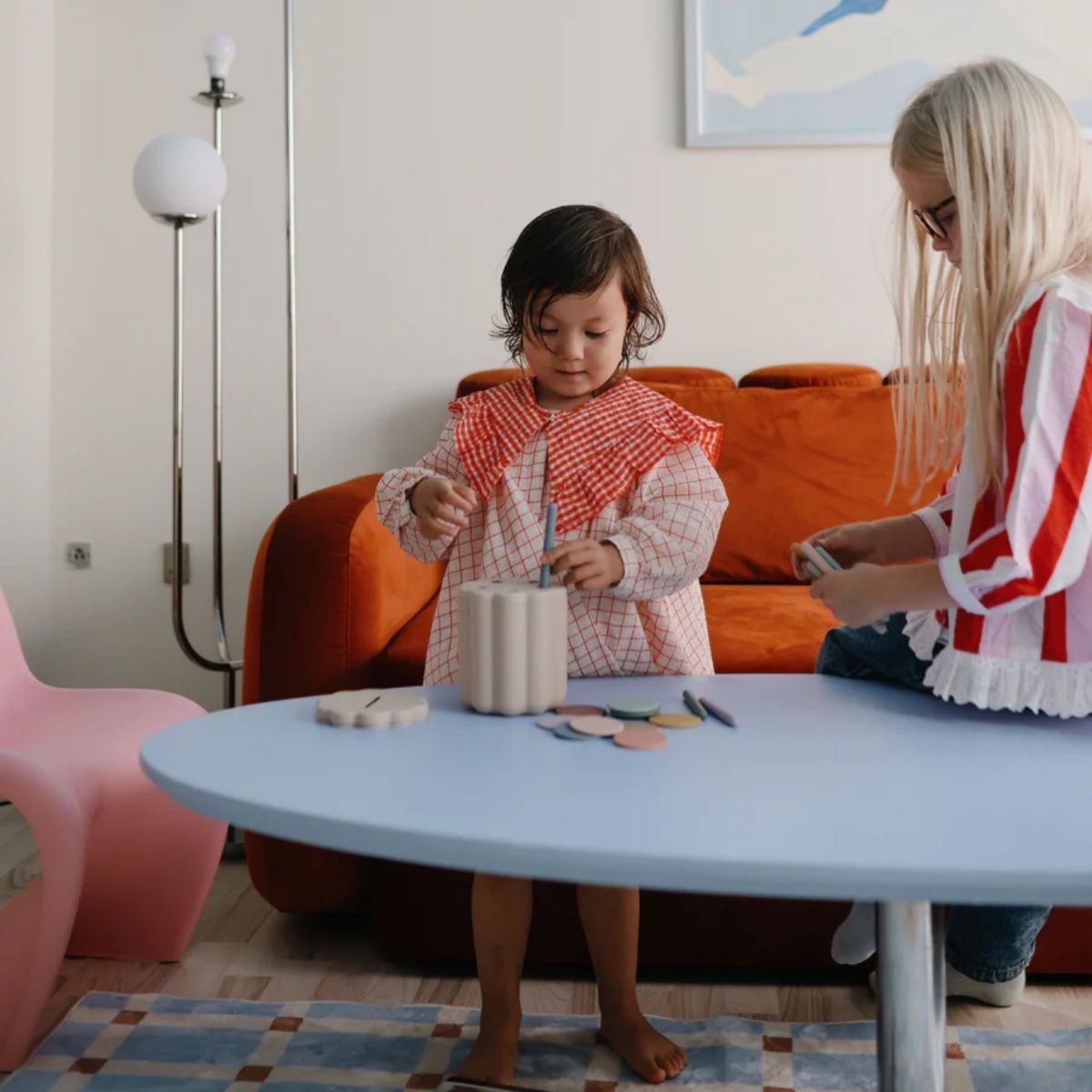 Girl putting the Mushie tubes into the box.