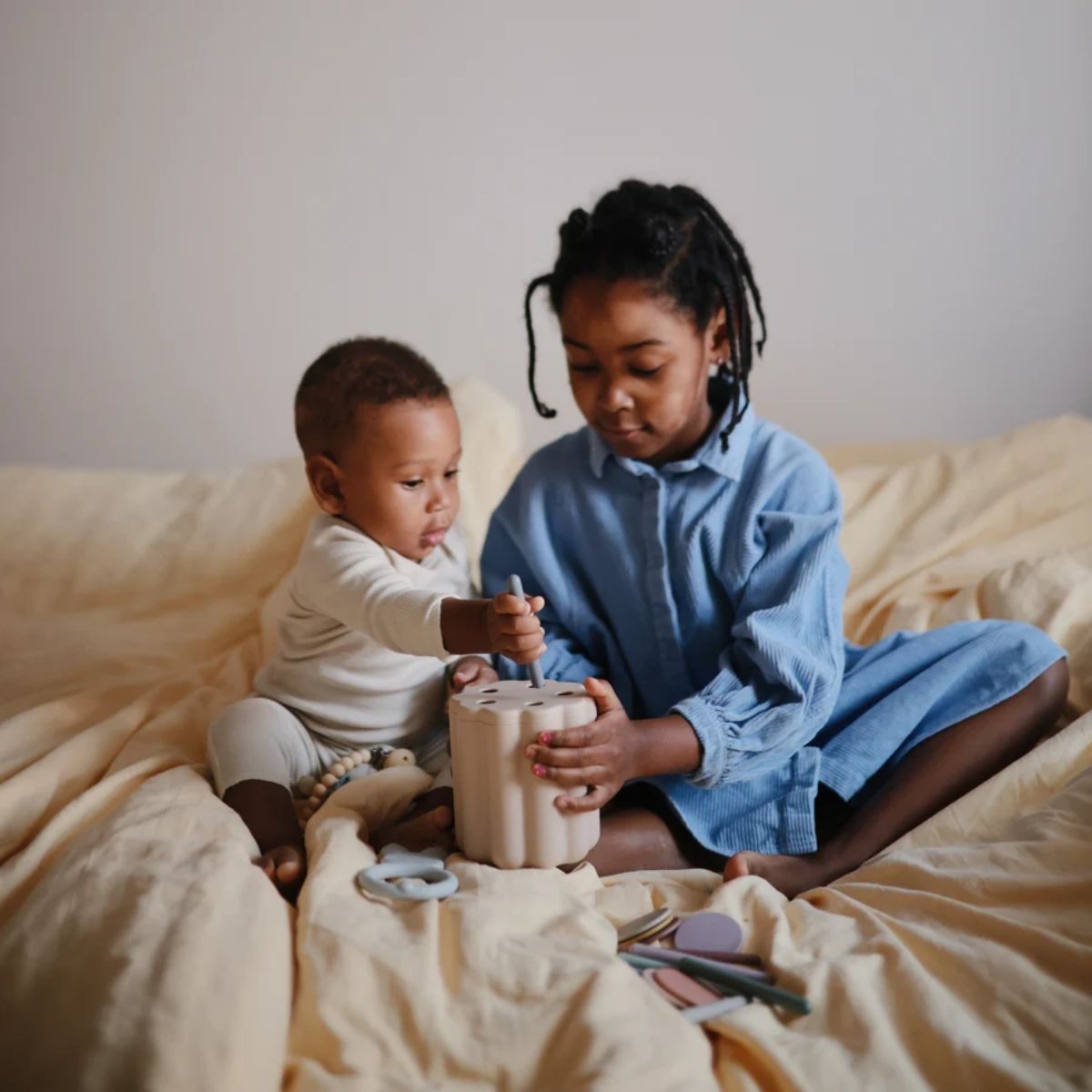 Mum and son playing with the tube and coin sorting set.