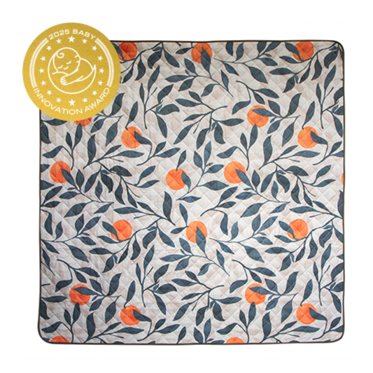 Floral patterned blanket with orange flowers and a baby innovation award badge on the top left corner.