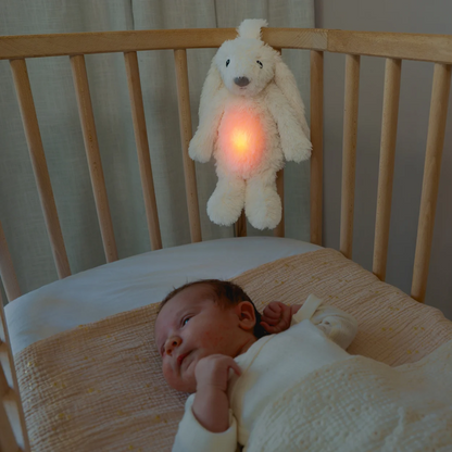 Ro the rabbi strapped onto the cot using red light and white noise to soothe the baby.