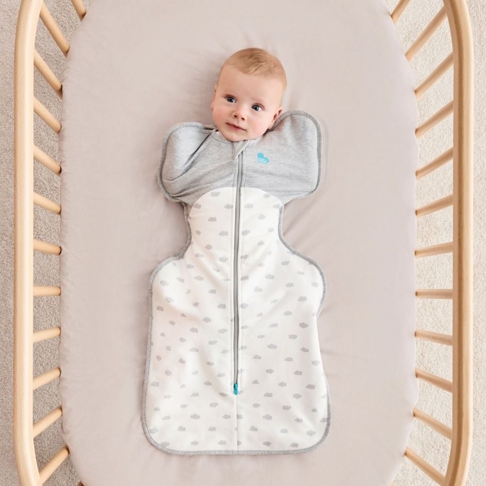 A 3 month old baby wearing the swaddle with his arms in.