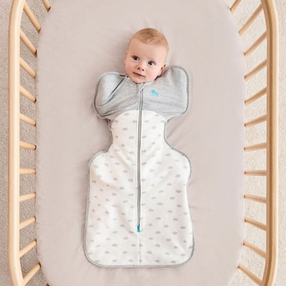 A 3 month old baby wearing the swaddle with his arms in.