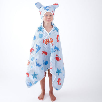 Child wearing a hooded towel with animal patterns on a white background